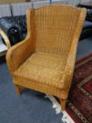A wicker wingback armchair.