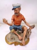A Capodimonte figure of a sailor (height 22cm).