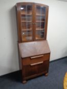 A 20th century oak bureau bookcase with leaded glass doors.