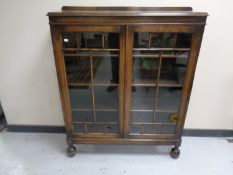 A 20th century oak double door glazed bookcase.