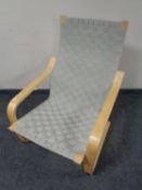 An IKEA armchair upholstered in a webbed fabric.