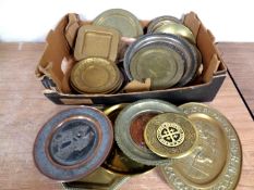 A box containing antique and later copper and metal trays and plates.