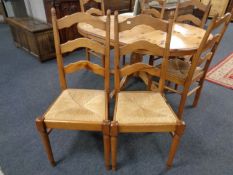 A circular pine pedestal extending dining table fitted with a leaf together with a set of six rush