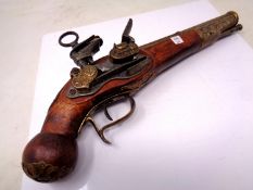 An ornamental flintlock pistol.