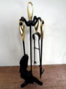 A four piece cast iron companion set on stand.