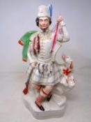 A Staffordshire figure of a man wearing a kilt.