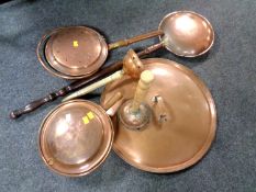 A wicker basket containing copperware including a copper tray, poss sticks, bed pans etc.