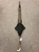 An antique parasol with mother of pearl and gold plated mounts