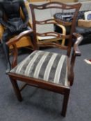 An Edwardian mahogany ladder back armchair.