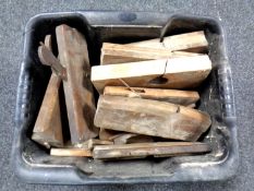 A box containing vintage woodworking planes.
