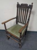 An Edwardian oak armchair.