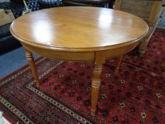 A circular pine extending dining table.