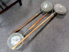 Three antique bed warming pans.