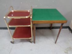 A 20th century gilt three tier tea trolley with lift off tray together with a folding baize topped