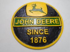 A cast iron wall plaque, John Deere.