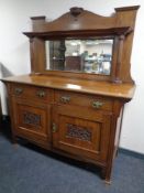 An Edwardian oak Arts and Crafts mirror back sideboard.