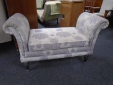 A contemporary window seat upholstered in floral fabric.