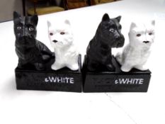 A pair of cast iron ornaments, Black & White scotch whisky.