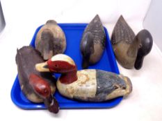Five wooden duck decoys.