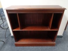 A set of mahogany open bookshelves.