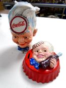 Two cast iron Coca-cola money boxes.