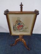 A Victorian rosewood tapestry pole screen on three-way pedestal.