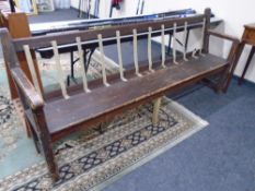 A painted pine railway style bench, height 93 cm, width 214 cm, depth 55 cm.