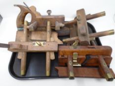 A tray containing four vintage plough planes.