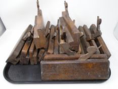 A tray containing a collection of vintage moulding planes.