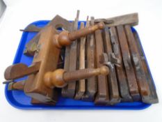 A tray containing assorted moulding planes together with a plough plane.