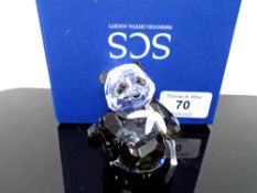 A Swarovski crystal ornament, seated panda cub with bamboo.