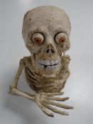 A cast iron skeleton money box.