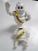 Two cast iron Michelin man money boxes.