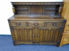 An oak buffet back sideboard.