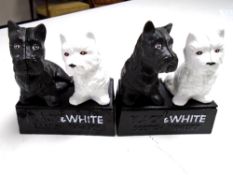 A pair of cast iron ornaments, Black & White scotch whisky.