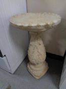 A concrete bird bath.