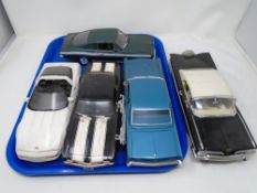 A tray containing five large scale die cast vehicles.