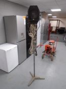 A vintage theatre spotlight on adjustable tripod.