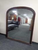A 19th century arch top overmantel mirror in oak frame.