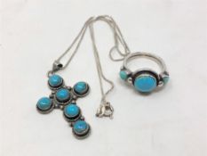 A sterling silver crucifix on chain mounted with turquoise together with similar dress ring.