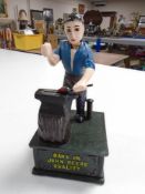 A cast iron novelty blacksmith money box from bank of John Deere.