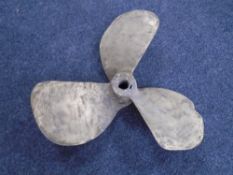 A heavy brass boat propeller.