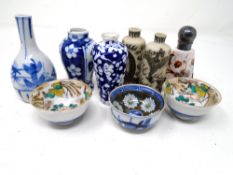 An antique hand-painted porcelain perfume bottle with silver top together with three miniature