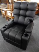 A contemporary reclining armchair with two cup holders.