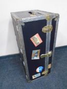 A shipping trunk bearing labels.