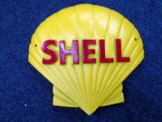 A cast iron Shell logo wall plaque.
