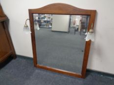 A contemporary overmantel mirror with fitted lights.