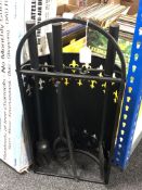 A four-piece cast iron companion set on stand.