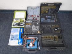 A box containing assorted boxed and cased toolkits, drill bits, Titan nailer,