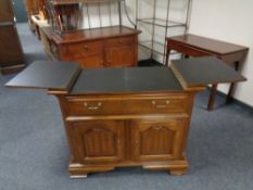 A contemporary mahogany effect side cabinet with fitted cupboards and a drawer